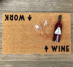 a bottle of wine sitting on top of a door mat next to a cork board