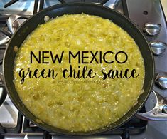 a pan filled with green chile sauce on top of a stove