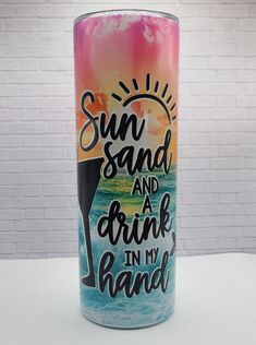 a candle with the words sun sand and a drink in my hand painted on it