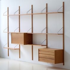 an empty room with shelves and drawers on the wall