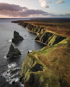 an aerial view of the ocean and cliffs