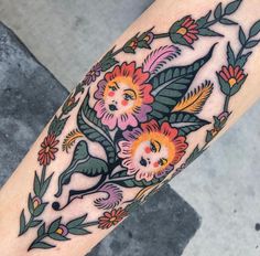 a woman's leg with flowers and leaves on it