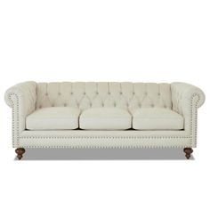 a white couch sitting on top of a wooden floor