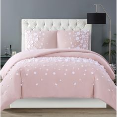 a pink bed with white flowers on it