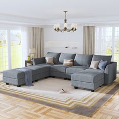 a living room filled with lots of furniture and a chandelier hanging from the ceiling