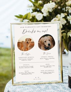 a bottle of wine sitting next to a sign with two dogs on it