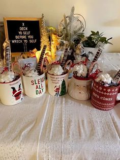 several mugs with christmas decorations on a table