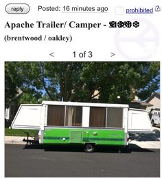 a green and white trailer parked in front of a house