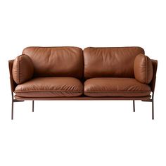 two brown leather couches sitting next to each other