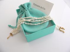 Overview:Every woman needs a strand of pearls ... but here's a piece that's more special than just any strand of pearls ... because it's made by Tiffany! :) Offered for sale is a wonderful Tiffany & Co. Picasso 18K Gold Buckle Multi Strand Pearl strand bracelet. Whether you are just starting your collection or are thinking of adding another piece, this one is perfect for you. This pearl bracelet is a gorgeous classic that will never go out of style. The piece is composed of 4 pearl strands with Pearl Strands, Strand Bracelet, Tiffany Heart, Heart Charm Bracelet, Multi Strand, Love Gifts, Tiffany & Co., Pearl Bracelet, Gold Bracelet