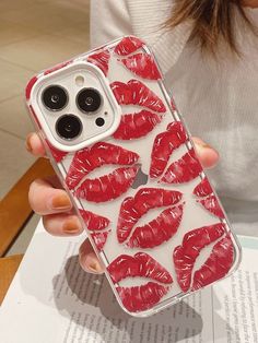 a woman is holding an iphone case with red lipstick on the phone and it's cover