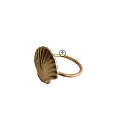 a gold ring with a shell on it