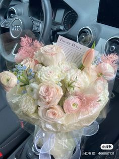 a bouquet of flowers sitting on top of a car dashboard