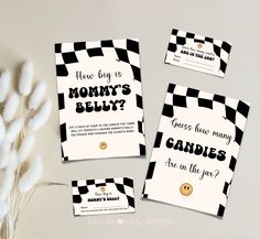 three cards with black and white checkered design, one has a smiley face on it