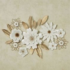 white and gold paper flowers on a beige background