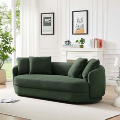 a living room with a green couch and white rug