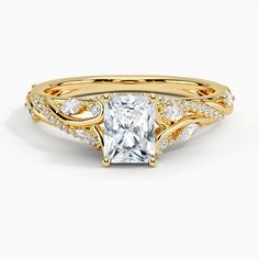 a rose gold engagement ring set with a princess cut diamond in the center and side stones