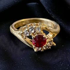 Gold plated ring with red garnet and cz diamonds. Great piece by seta jewelry Vintage costume jewelry size 5.5 Red Crystal Ring With Accent Stones In Cubic Zirconia, Red Diamond Open Ring, Red Open Diamond Ring, Red Diamond Birthstone Ring For Formal Occasions, Formal Red Crystal Diamond Ring, Red Cubic Zirconia Crystal Ring With Gemstone, Red Rings With Diamond Accents For Anniversary, Red Crystal Promise Ring With Stone Setting, Red Crystal Ring With Stone Setting For Promise