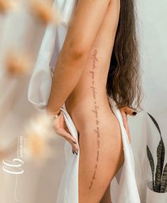 the back of a woman's body with writing on it