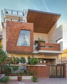 a large brick building with plants on the balcony