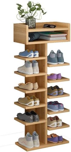 a wooden shoe rack with several pairs of shoes on it and a potted plant in the corner