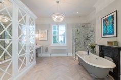 a large bathroom with a claw foot tub