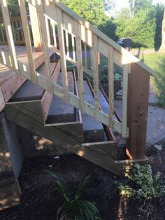 a wooden staircase going up the side of a house