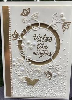 a white card with gold foil on it and the words, wishing you love and happy memories