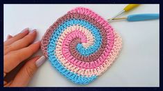 someone is crocheting a square with yarn