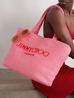 Jimmy Choo's 'Avenue' tote is part of the label's beach edit, making it ideal for your next getaway. It's woven from 'Candy Pink' soft raffia and embroidered with red lettering across the front. There's plenty of space inside for a towel, pareo and flip flops. Chic Summer Bags With Embroidered Logo, Summer Shopping Bags With Embroidered Logo, Summer Rectangular Bag With Embroidered Logo, Designer Summer Straw Bag For Shopping, Designer Straw Bag For Summer Shopping, Designer Summer Straw Shopping Bag, Designer Straw Bag For Beach, Designer Summer Beach Bags, Designer Woven Summer Bags