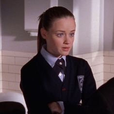 a woman in uniform standing next to a sink