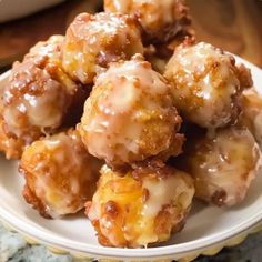 a white plate topped with donuts covered in glaze