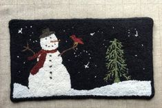 a snowman with a red scarf on it's lap