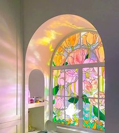 a bathroom with a large stained glass window