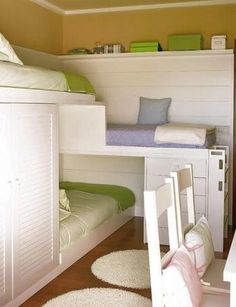 a bedroom with bunk beds and desks next to each other on carpeted flooring