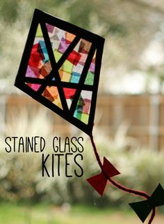 the stained glass kite is being held up