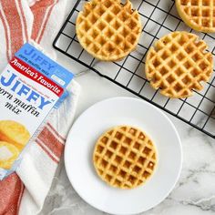 several waffles on a cooling rack next to a bag of jelly