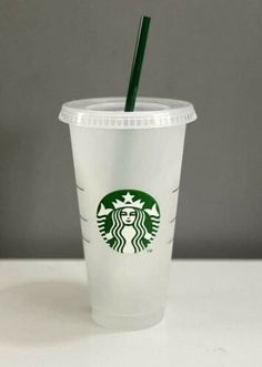 a starbucks cup with a green straw in it