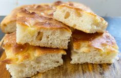 several pieces of bread sitting on top of a wooden cutting board