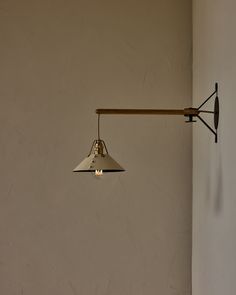 a lamp hanging from the side of a wall