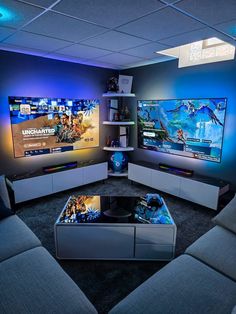 a living room filled with furniture and two flat screen tvs mounted on the wall