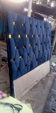 an upholstered headboard made out of blue velvet