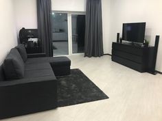 a living room filled with furniture and a flat screen tv