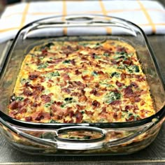 a casserole dish with bacon, cheese and spinach in it on a table