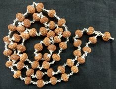 "Product  Name :  8 Mukhi Rudraksha Mala In Pure Silver  / Rare 8 Mukhi Ganesha Mala In Silver Bead size : 9 MM Number of Beads : 54+1 Length of Mala : 30 inches (from ist bead till last bead) / 15 inches (around the neck) Design :  8 mukhi java beads are design as a mala In Silver wire with silver caps on all beads  Description : 8 mukhi Rudraksha is the second form of reflection of the first son of Lord Shiva, Lord Ganesh and is one who is worshipped prior to other gods.  It removes obstacles in path , destroys evils & bring success in all undertakings ,wearer is blessed with knowledge , wisdom & wealth. Destroyer of obstruction. As the name symbolize it destroy obstruction  and gives  achievements in all ventures.  The 8 mukhi Rudraksh  bead is also represented by Lord Ganesha who is wo Ketu Mantra, Rudraksha Mala, Shiva Lord, Silver Caps, Lord Ganesha, Silver Bead, Prayer Beads, Lord Shiva, Ganesha