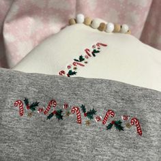 a christmas sweater with candy canes on it and the word merry written in red