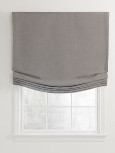 a gray roman blind in front of a window