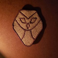 a close up of a small patch with a cat on it's back side