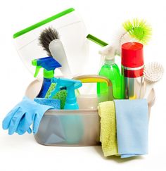 cleaning supplies including gloves, sponges and other items in a dish on a white background