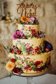 a three tiered cake with flowers on it